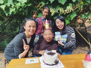boy with cerebral palsy with his grandma and nonprofit staff