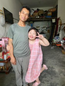 girl with Down syndrome and her father
