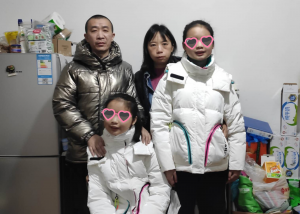 family picture of twin girls, both blind, one with epilepsy and cerebral palsy and their parents