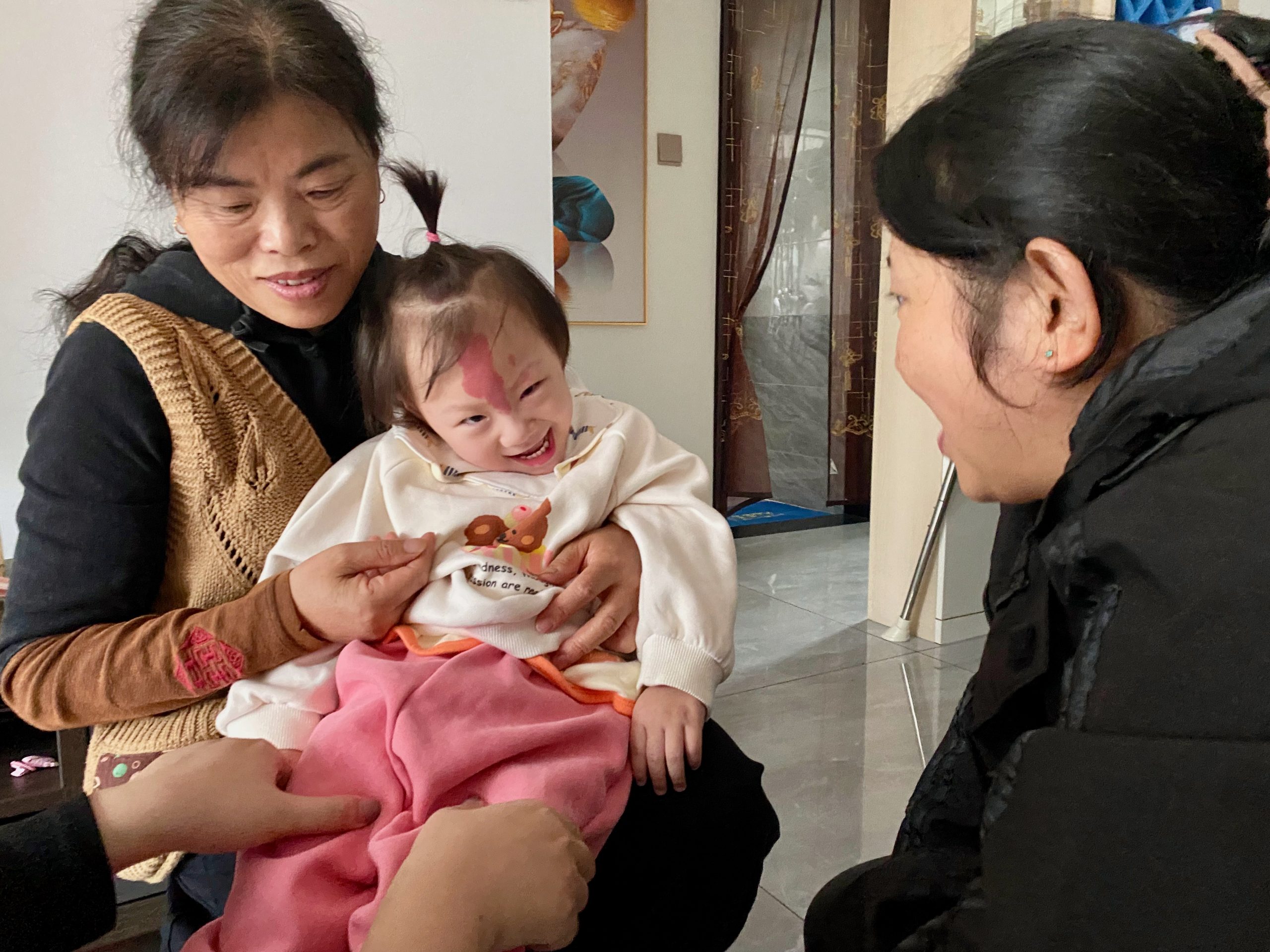 Han Han and her grandmother receiving encouragement from Hope Station staff