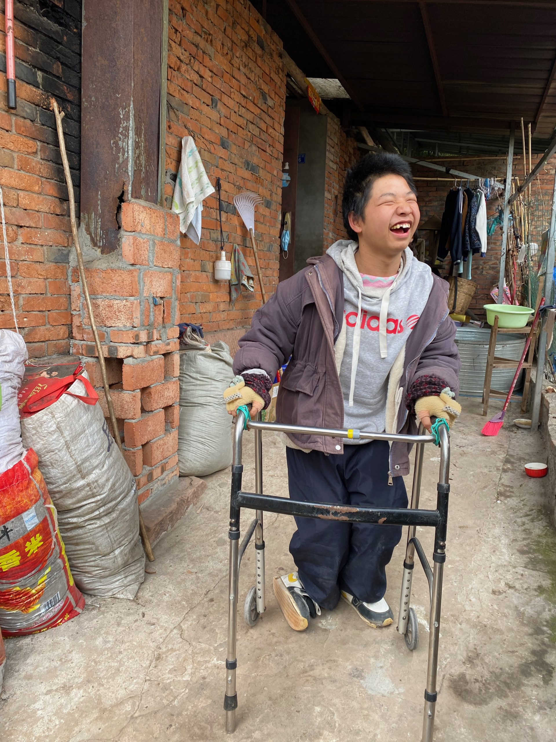 Long Long smiling while using his walker