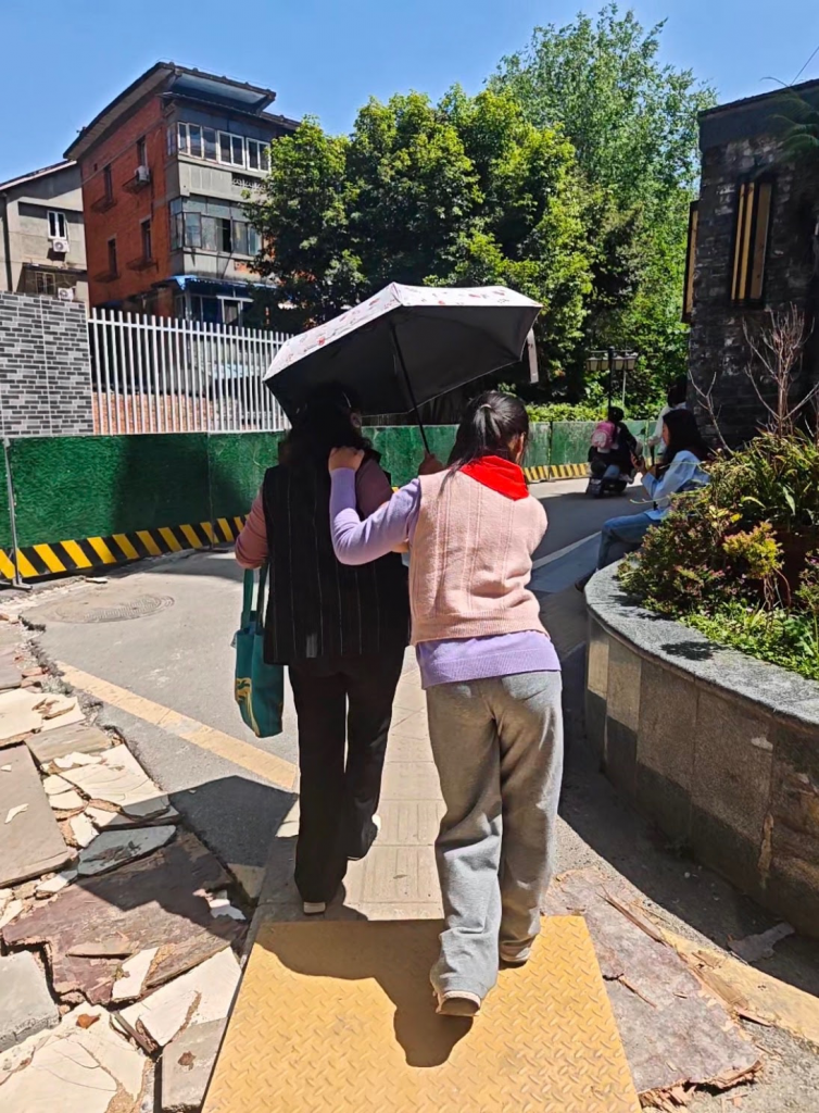 blind girl with cerebral palsy with her grandma walking to school together