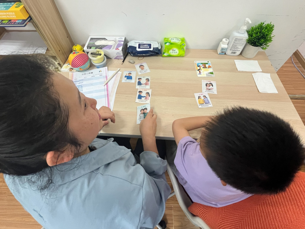 nonprofit therapist having a therapy session with boy with autism